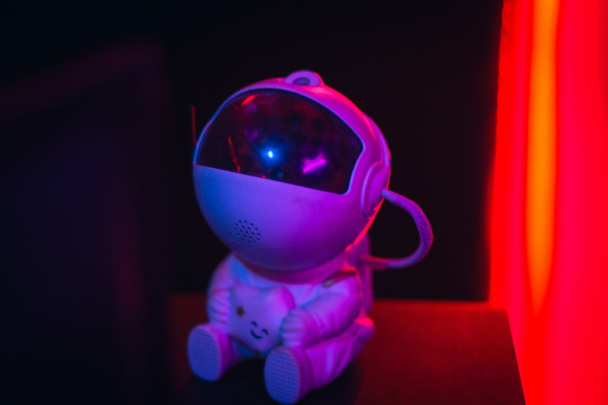 A small astronaut toy with a glowing blue light